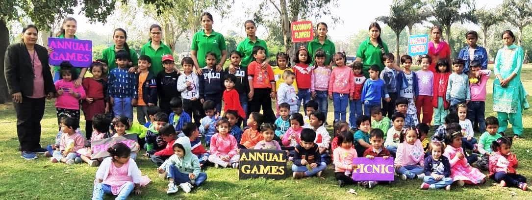 Children and teachers at the annual games and picnic in a park
