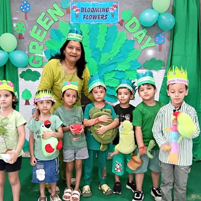 Meenakshi Ma'am with children in green leaf crowns on Green Day