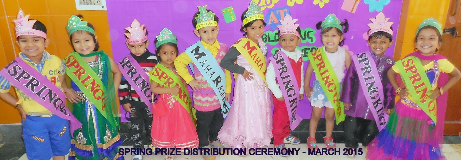 Children in crowns and sashes at the spring prize distribution